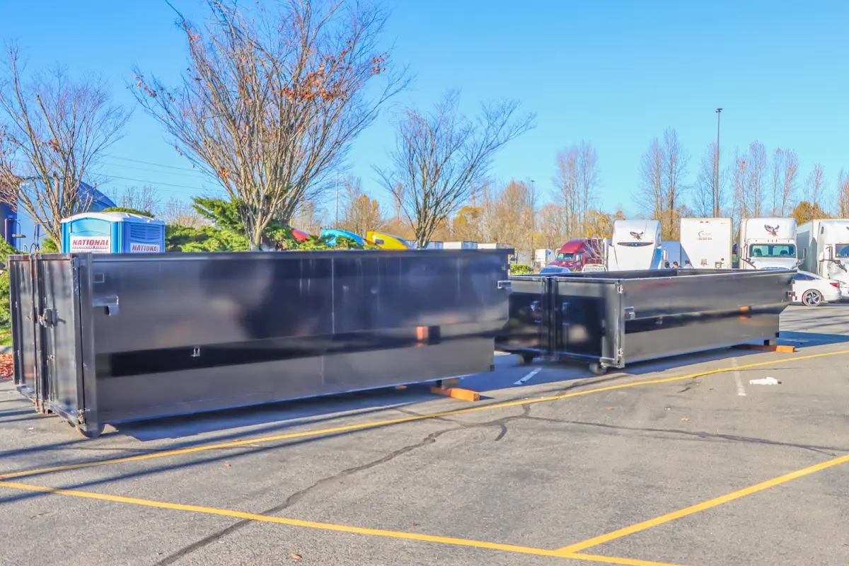 Professional dumpster rental service with roll-off container on residential driveway in Greenbriar